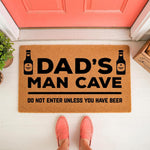 Dad's Man Cave doormat with beer bottle graphics and funny text, a natural coir fiber welcome mat for a garage or basement entrance that reads do not enter unless you have beer, perfect for a humorous home decor gift for a father.