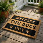 Don't Let The Dogs Out coir doormat with black text and paw print accents, a funny pet lover welcome mat for front porch entryways that makes a humorous housewarming decor piece for any dog owner home entrance or mudroom floor.