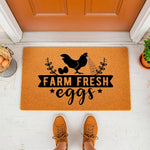 Farm Fresh Eggs doormat featuring a black chicken and egg design on a natural coir welcome mat, perfect for farmhouse porch decor or a rustic entryway floor rug, shown on a front porch with a bucket of eggs and brown sneakers.