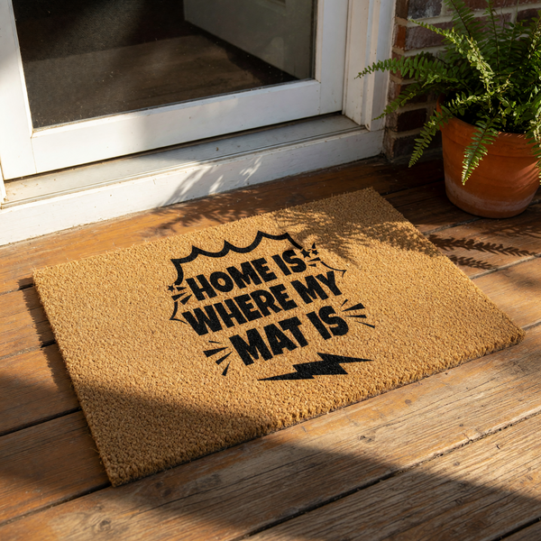 Funny welcome doormat with Home Is Where My Mat Is text, a natural coir fiber outdoor rug for front porch decor, featuring a bold comic book style design with a lightning bolt graphic for a stylish and modern housewarming gift