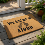 Pineapple welcome doormat with tropical island theme, featuring the text You had me at Aloha printed on natural coir fiber.