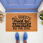 Dog lover welcome doormat featuring the funny quote All Guests Must Be Approved By The Dog, this natural coir fiber entry rug is a stylish front porch decor piece for pet owners and makes a humorous housewarming entrance mat for