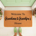 Grandma and Grandpa welcome doormat for front porch, featuring natural coir fiber material with black text that reads Welcome To Grandma & Grandpa's House, perfect for a personalized home entrance decor and entryway floor mat.