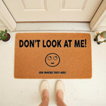 Funny doormat with text Don't Look At Me and IDK Where They Are, featuring a rolling eyes emoji on a natural coir fiber welcome mat, perfect for a humorous front porch decor entrance that greets guests with a sarcastic