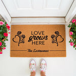 Personalized Love Grows Here doormat featuring a floral rose heart design on natural coir fiber, perfect as a custom family name welcome mat for your front porch entry, housewarming gift, or stylish home decor for any front door.