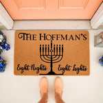 Personalized Hanukkah doormat featuring a black menorah design and the text Eight Nights Eight Lights on a natural coir welcome mat, perfect for a festive holiday front porch entrance with a family name display.