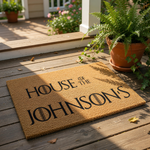 Personalized family name doormat featuring custom text on a natural coir fiber welcome mat, perfect for a front porch entry.