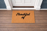 Thankful AF coir doormat for front porch entry, featuring a funny quote in black script on a natural fiber welcome mat.