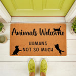 Animals Welcome Humans Not So Much doormat, a funny coir welcome mat for pet lovers featuring cat and dog silhouettes, placed on a front porch entryway to create a humorous home decor statement for animal owners and pet