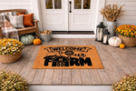 Farmhouse welcome doormat with a barn and windmill design on a rustic porch, featuring a natural coir welcome mat for front door entryways that adds a cozy country style to your home decor for the fall season and beyond.