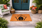 All We Need Is Cake doormat featuring a cupcake and whisk design on a natural coir welcome mat, perfect for a kitchen entryway or front porch decor, this durable outdoor floor mat adds a fun baking theme to your home entrance.