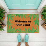 Welcome to Our Joint doormat with cannabis leaf print, a funny coir welcome mat for front porch decor featuring green marijuana leaves on a natural fiber rug, perfect for a housewarming gift or a humorous home entrance floor mat.