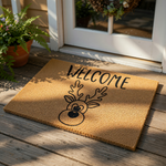 Reindeer welcome doormat made of natural coir fiber, featuring a cute black line art deer face and the word Welcome printed in a modern font for a festive holiday porch decor look that is perfect for your front door entrance.