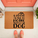 Dog lover welcome doormat featuring a house and paw print design on natural coir fiber, this funny pet owner entry rug makes a cute front porch decor piece for any home that is not a home without a dog, shown on a porch with