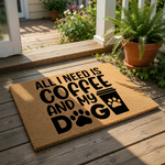 Coffee and dog lover doormat featuring a natural coir fiber texture with black text that reads All I Need Is Coffee And My Dog, complete with a paw print and coffee cup graphic for a fun front porch welcome mat or entryway rug