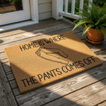 Funny doormat with pants illustration and text reading Home Is Where The Pants Comes Off, this natural coir fiber welcome mat is a humorous front porch decor piece for your home entrance, entryway, or apartment door decor.