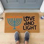 a door mat that says love and light with a menorah on it