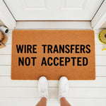 Funny Wire Transfers Not Accepted doormat for front porch entry, featuring bold black text on a natural coir fiber welcome mat, perfect for a humorous home decor entrance or a sarcastic housewarming gift for a new homeowner.