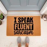 Funny I Speak Fluent Sarcasm doormat made of natural coir fiber, featuring bold black text on a tan welcome mat placed at a front door entrance, perfect for a humorous home decor entryway or a sarcastic housewarming gift for