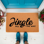 Jingle All The Way Christmas doormat featuring natural coir fiber material, displayed on a front porch with festive holiday decor, perfect for a seasonal welcome mat or outdoor entryway rug for your home during the winter