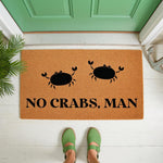 Funny crab doormat with the text No Crabs Man printed in black on a natural coir fiber welcome mat, featuring two cute crab illustrations for a coastal or beach house porch decor entryway floor rug that greets your guests.