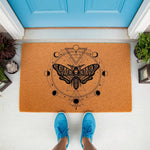 Moth skull doormat with celestial moon phase design on a natural coir welcome mat, featuring a mystical insect print for a gothic porch decor look that adds a dark occult touch to your front door entrance and home entryway floor.