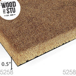 A close-up view of a black textured surface, with a portion of a brown, textured object partially visible on the right side.