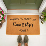 Personalized Nana and Pop's house doormat made of natural coir fiber, featuring a custom welcome mat design for grandparents placed on a front porch, perfect for a home entrance or a thoughtful housewarming gift for family
