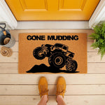 Gone Mudding monster truck doormat featuring a rugged off-road vehicle design on natural coir fiber, perfect for a front porch welcome mat, outdoor entry rug, or a fun housewarming gift for truck and mud racing enthusiasts.