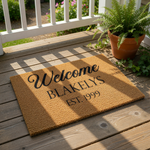 Personalized family name welcome doormat featuring custom text and established year on natural coir fiber, this durable outdoor entry rug makes a stylish housewarming decor piece for any front porch or home entrance.