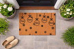 Personalized family Christmas doormat featuring hanging ornament designs with Mom and Dad titles, printed on a natural coir welcome mat with snowflake patterns for a festive holiday porch decor look on a tiled entryway floor.
