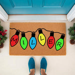 Personalized Christmas light doormat featuring colorful holiday bulb illustrations on a natural coir welcome mat, perfect for festive front porch decor and custom family name entryways during the winter season and holiday home