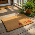 Ho Ho Ho Christmas doormat featuring a natural coir fiber texture with bold red lettering, this festive holiday welcome mat is a durable outdoor floor rug for your front porch decor during the winter season and holiday home entry.