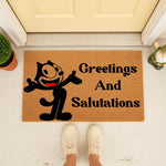Cartoon cat welcome doormat featuring a black feline character and the text Greetings And Salutations, this natural fiber coir floor mat is a funny front porch decor piece for your home entrance and outdoor entryway floor.