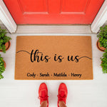 Personalized family name doormat with this is us text on a natural coir welcome mat, featuring a custom front porch floor mat design for home entryways that makes a housewarming or wedding decor piece for any front door entrance.