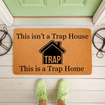 Funny Trap Home doormat for front porch entry, featuring a humorous house design on natural coir fiber.