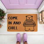 Come In And Chill bear doormat featuring a cute bear in a sweater design on natural coir fiber, this funny winter welcome mat is perfect for a front porch entryway and adds a cozy look to your home decor for the holiday season.