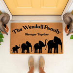 Personalized family name coir doormat featuring a black elephant herd silhouette and the text Stronger Together, placed on a front porch as a custom welcome mat for home decor, housewarming gift, or unique entryway floor rug.