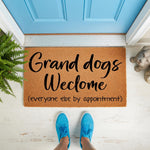 Grand dogs welcome doormat for pet lovers, a funny coir welcome mat with black script text placed on a porch, perfect for dog owners who want a humorous front door rug that says everyone else by appointment for their home