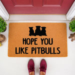 Pitbull dog welcome doormat with three dog silhouettes and funny text on a natural fiber rug, placed on a front porch entryway for pet lovers who want a humorous outdoor floor mat for their home entrance and dog decor.
