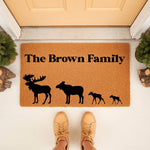 Personalized family name moose doormat featuring a custom surname and a silhouette of a moose family, this natural coir welcome mat is a rustic outdoor floor rug for your front porch entrance and home decor entryway.