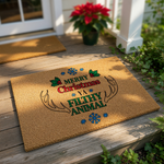 Merry Christmas Ya Filthy Animal doormat featuring festive holiday text, holly leaves, and reindeer antlers on a natural coir fiber welcome mat, perfect for funny seasonal front porch decor and winter home entryway floor mats.