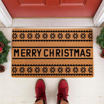 Merry Christmas coir doormat with a black snowflake and scalloped border design, featuring a natural fiber welcome mat placed on a porch for holiday home decor, perfect for a festive front door entrance during the winter season.