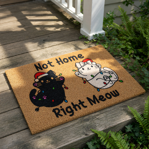 Funny cat Christmas doormat featuring two cute kittens tangled in holiday lights and wearing Santa hats, with the text Not Home Right Meow printed on a natural coir fiber welcome mat for a festive holiday home entryway decor.