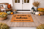 Grandkids Welcome doormat for front porch, a natural coir fiber welcome mat featuring black text and heart designs, perfect for a grandparent home entrance with fall decor, pumpkins, and flowers on a rustic wood deck floor.