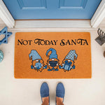 Funny holiday doormat featuring three blue gnomes with a menorah and dreidel, perfect for a winter porch entrance.
