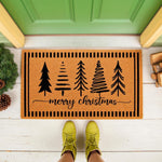 Merry Christmas doormat with black pine tree designs and striped border, a natural coir fiber welcome mat for holiday porch decor, featuring festive winter trees and script text on a durable outdoor rug for your front door