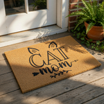 Cat Mom coir doormat featuring black printed text and feline ears, this natural fiber welcome mat is a fun front porch decor piece for any pet lover looking for a durable outdoor rug for their home entrance or entryway floor.