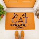 Cat Mom welcome doormat featuring a cute feline ear design and arrow accents on a textured orange mat, perfect for a pet lover home entrance.