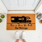 Personalized camper doormat featuring a black motorhome graphic and the phrase This is How We Roll, perfect for a camping welcome mat or outdoor porch decor for a family who loves travel and road trips in their recreational